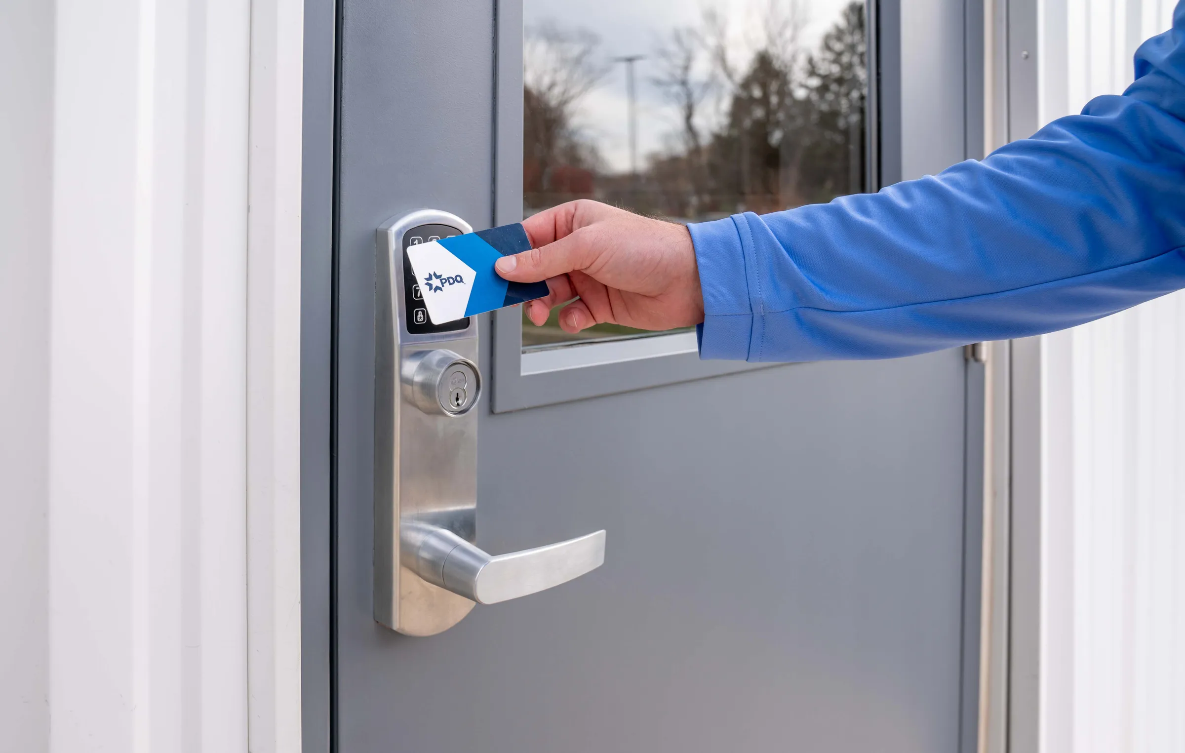 A card opens a PDQ Spirit 6EWS exit trim on a commercial door